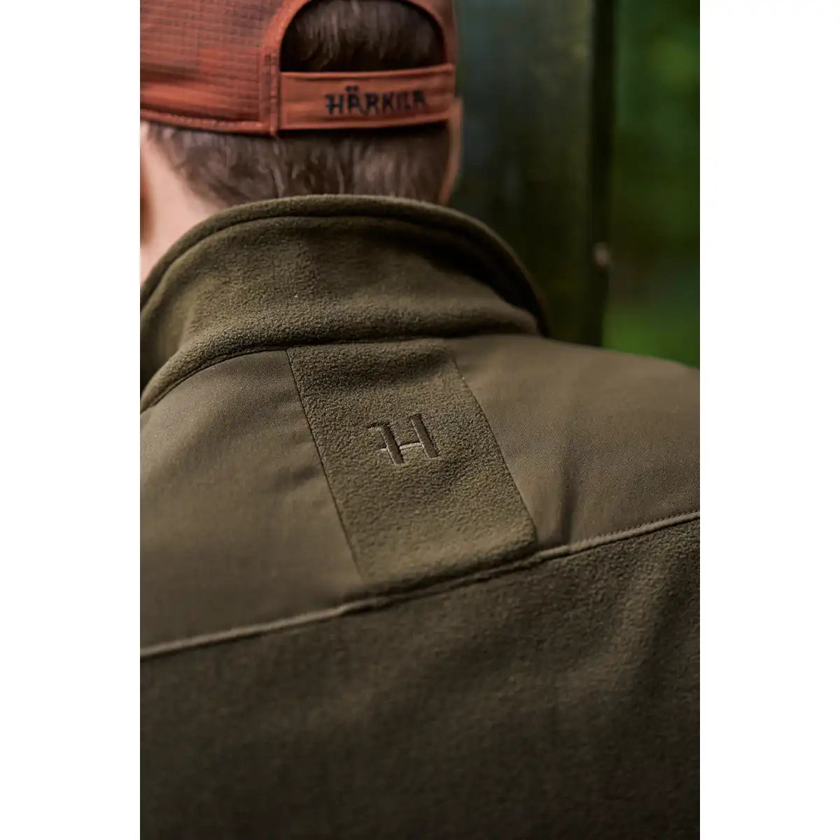 Härkila Fjell Fleece Waistcoat - Worn by Model - Back Logo Close Up Härkila Fjell Fleece Waistcoat - Worn by Model - Back Logo Close Up