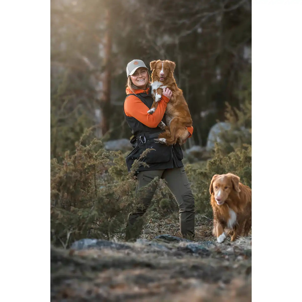 Pinewood Dog Sports Womens Trainer Vest- Black - lifestyle model with dogs Pinewood Dog Sports Womens Trainer Vest- Black - lifestyle model with dogs