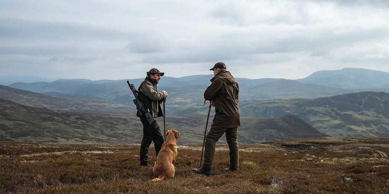 Gamekeeper and farm worker on estate ground in practical summer workwear
